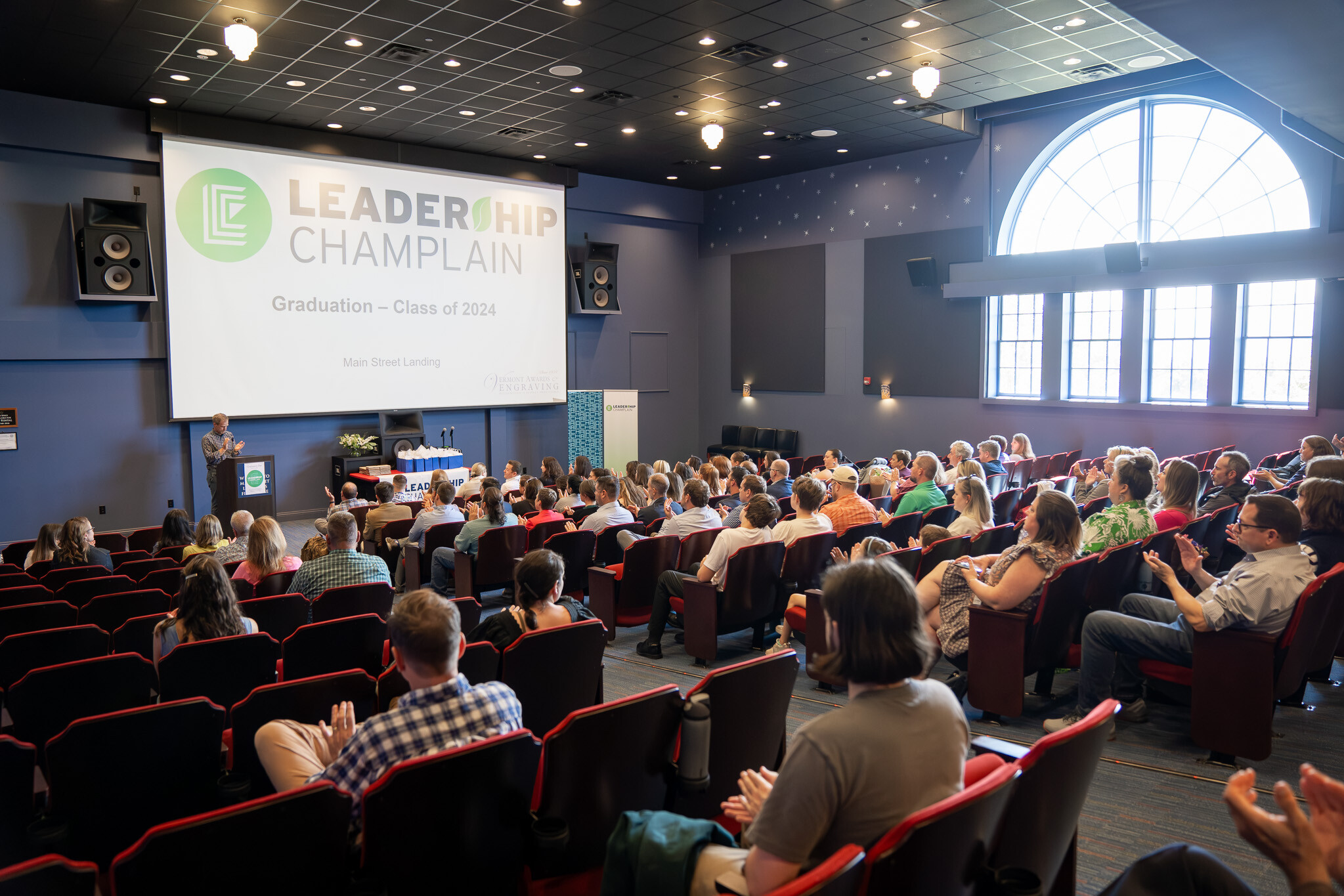 Graduation ceremony for Leadership Champlain Class of 2024 in a theater setting.