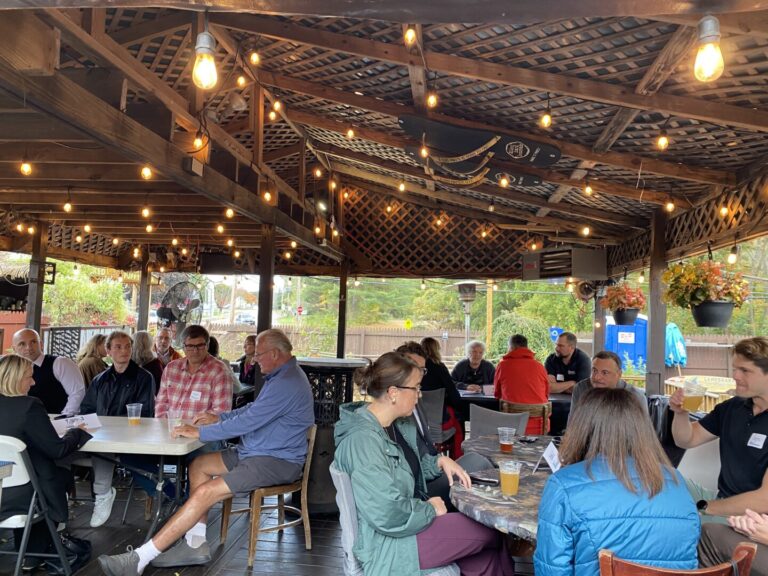 Attendees networking during an LCC legislative speed networking event at an outdoor venue in Vermont
