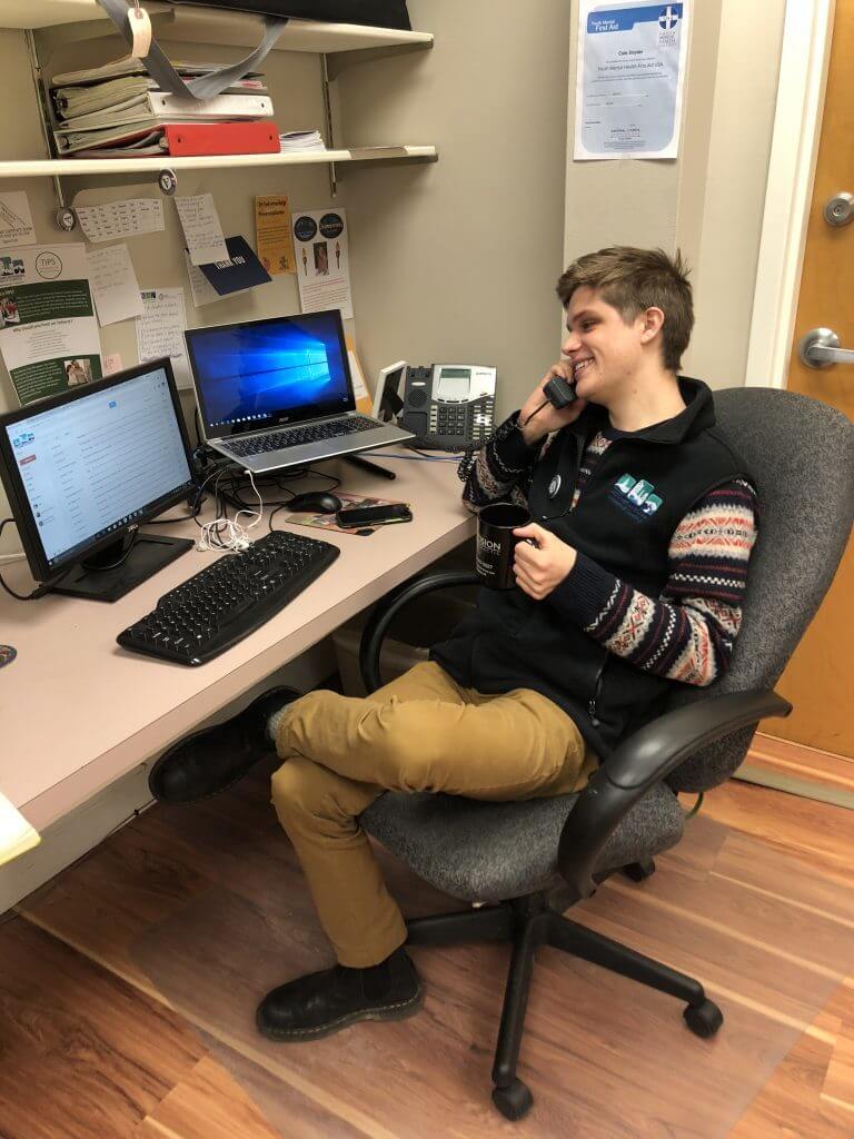 Vista AmeriCorps member, Cole Snyder, talking on the phone