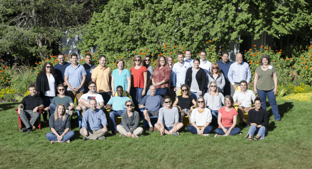 A group of people sitting in a field