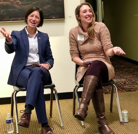 photo of US Attorney Christina Nolan and facilitator Kim Anderson sitting at the front of the room laughing