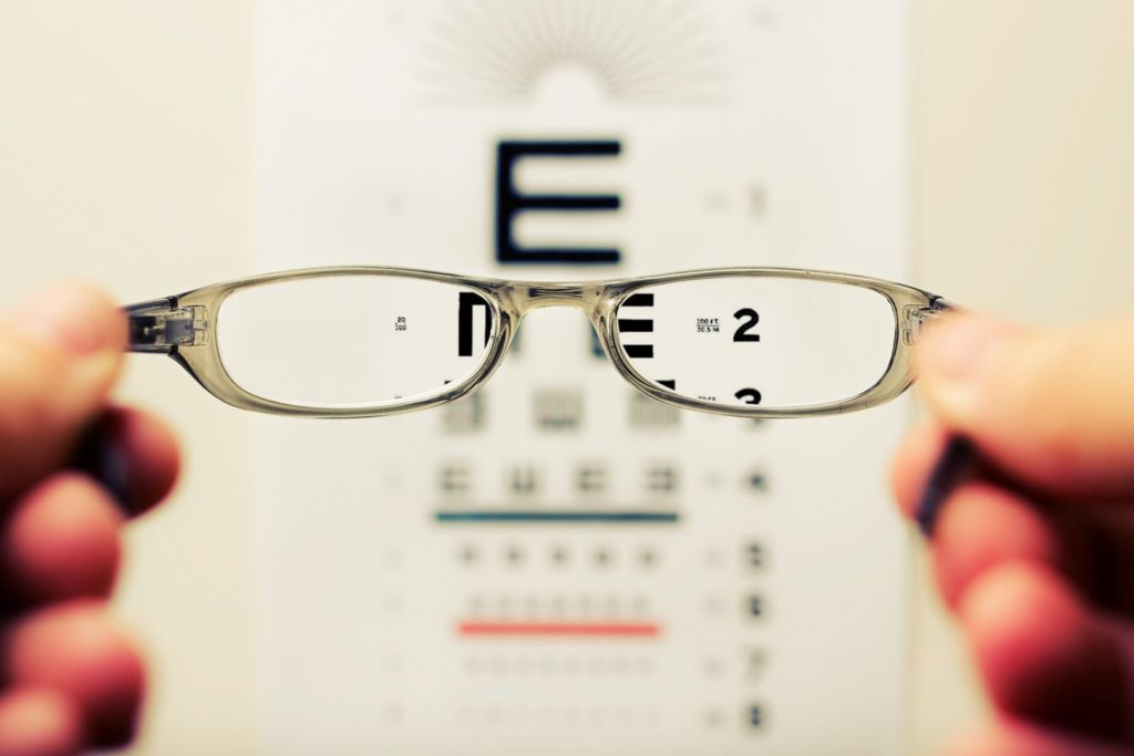 eye glasses looking at an eye chart