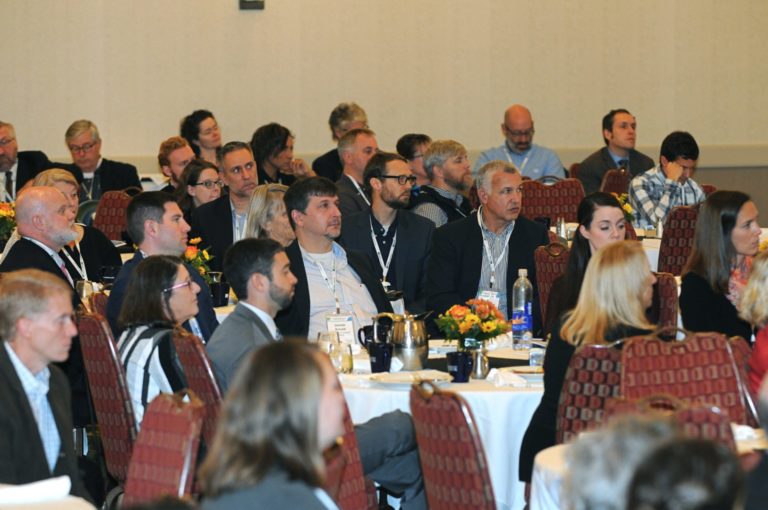 photo of group listening to speaker at conference