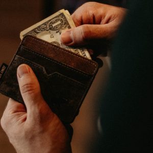 Man holding a wallet pulling money out